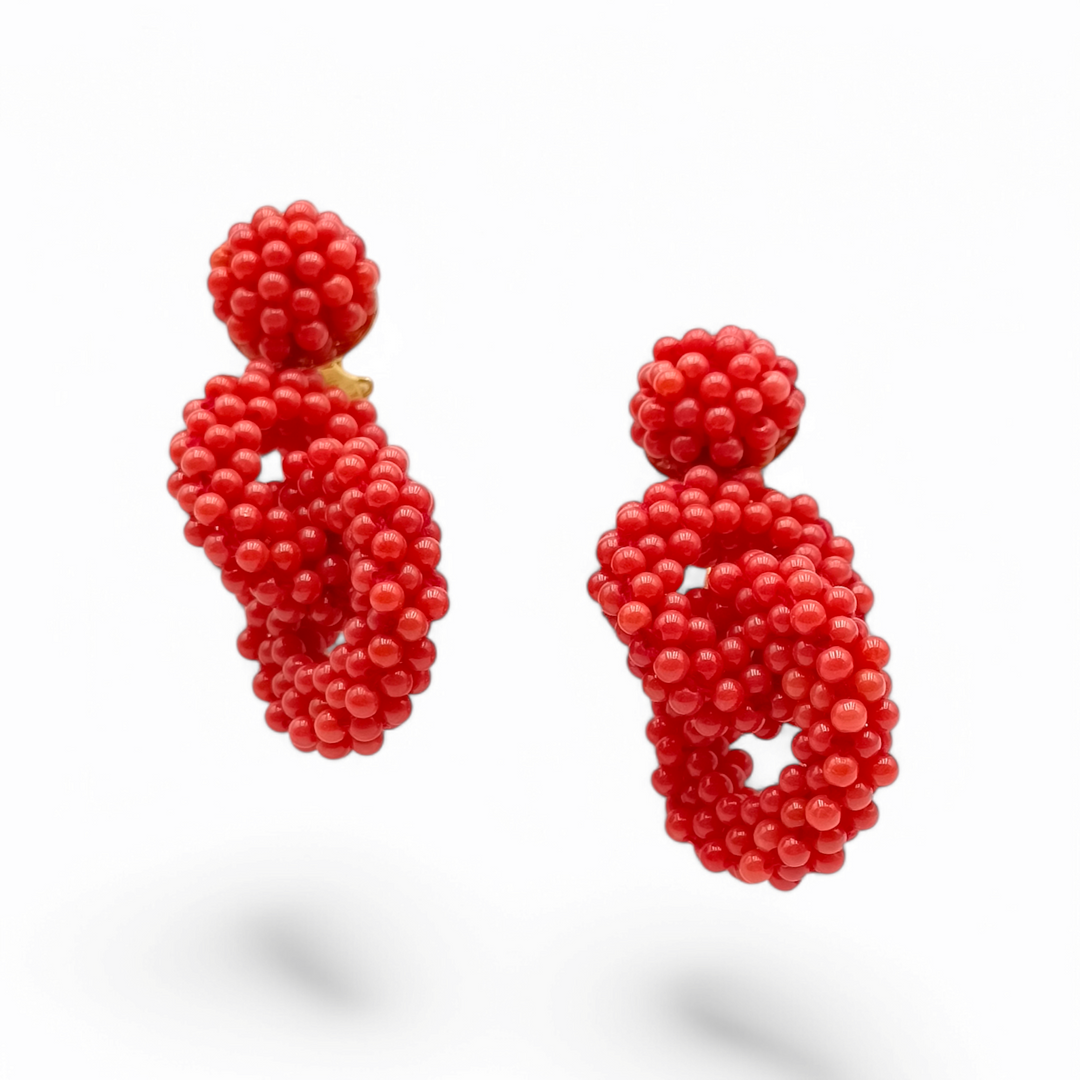 Woven red coral knot earrings mounted on silver