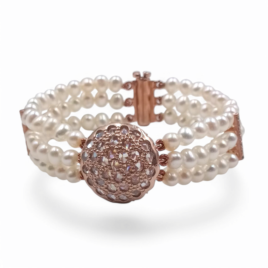 Multi-strand pearl bracelet with Swarovski patch mounted on copper silver