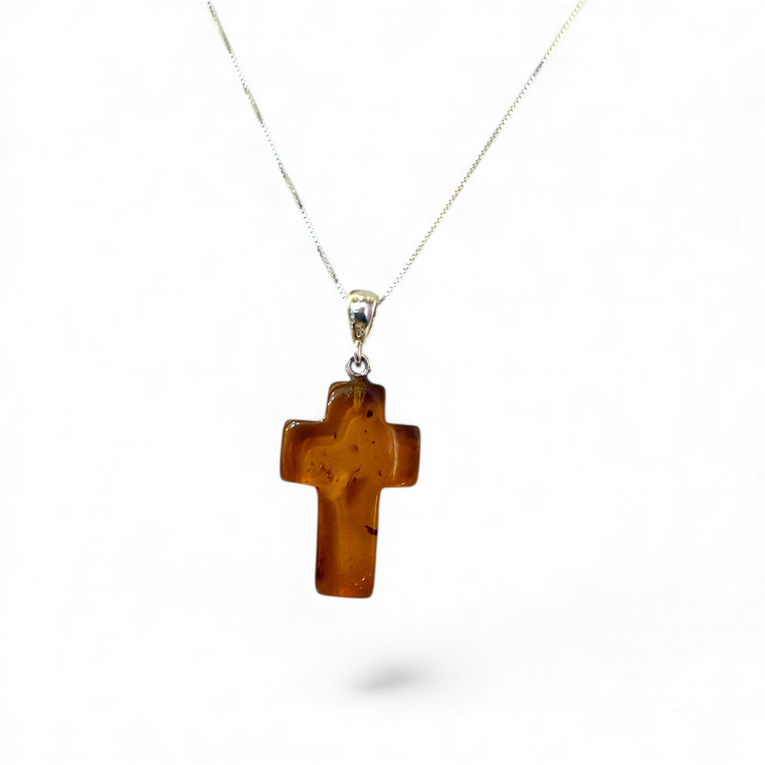 Amber cross pendant mounted in silver