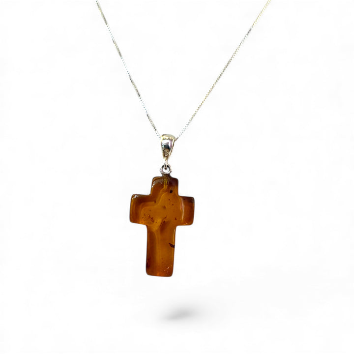 Amber cross pendant mounted in silver
