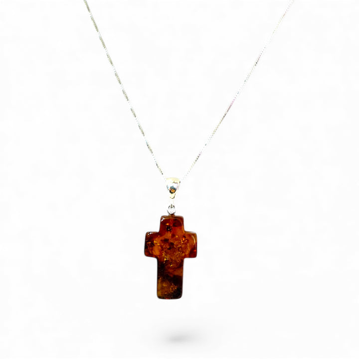 Amber cross pendant mounted in silver