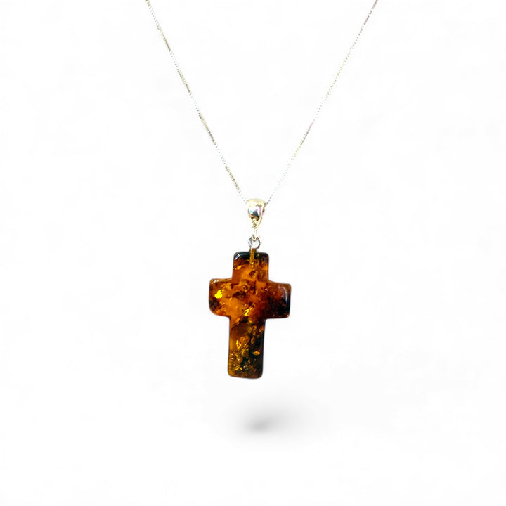 Amber cross pendant mounted in silver