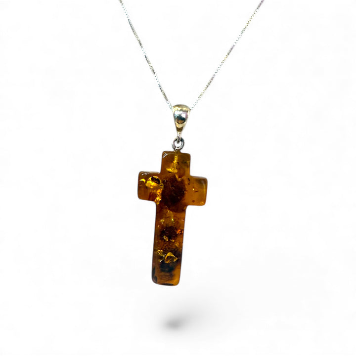 Amber cross pendant mounted in silver