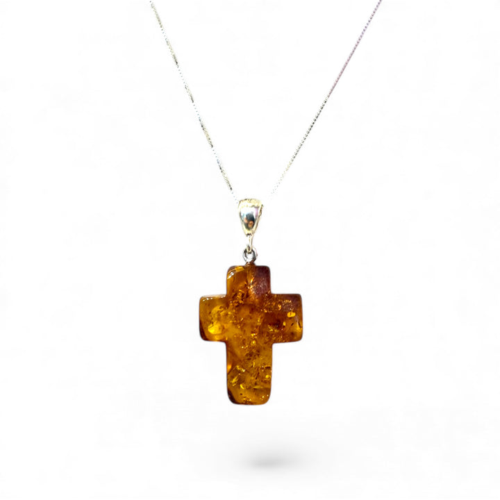 Amber cross pendant mounted in silver