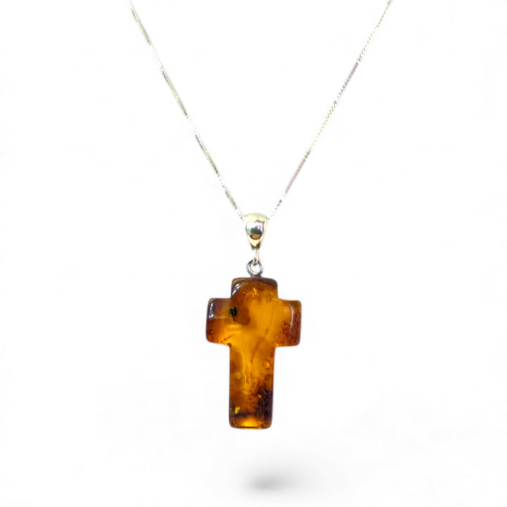 Amber cross pendant mounted in silver
