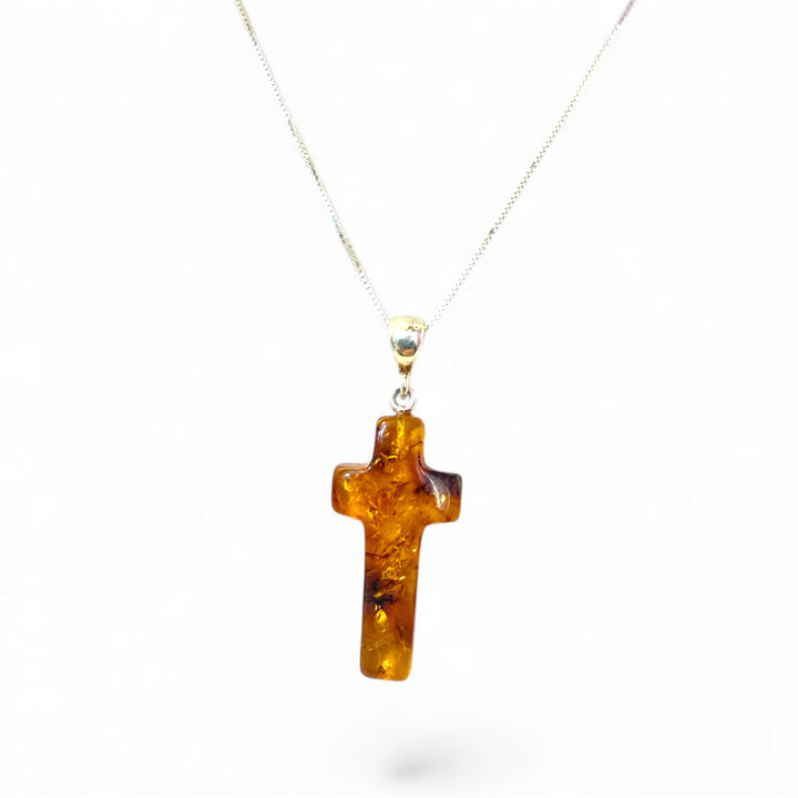 Amber cross pendant mounted in silver