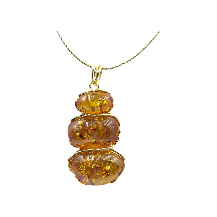 Red amber tris pendant mounted on silver