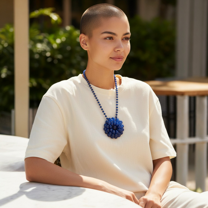 Collana con Fiore e Perle di Ambra blu montata in Ematite Dorata