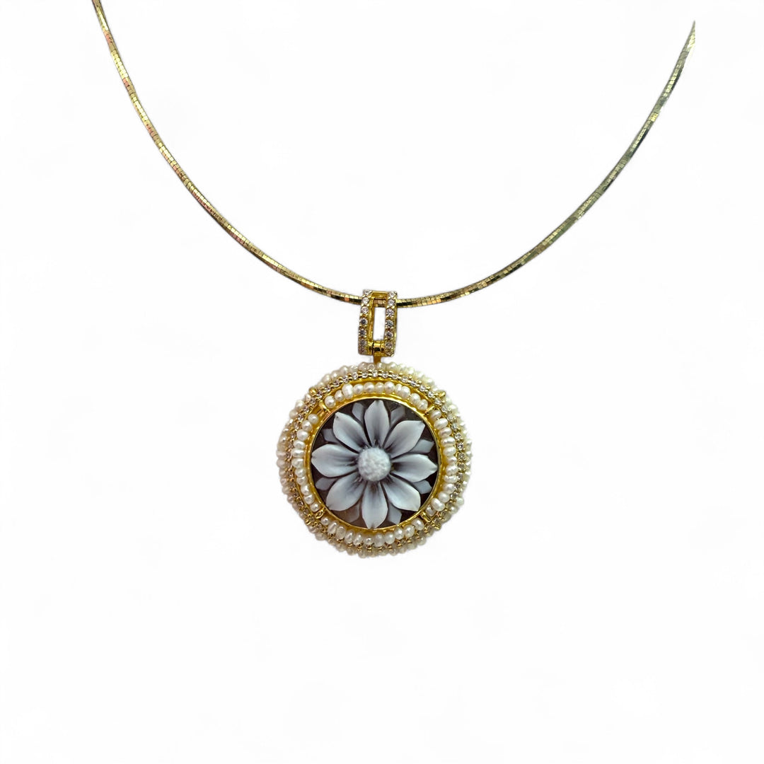 Cameo flower pendant necklace mounted on woven coral and silver