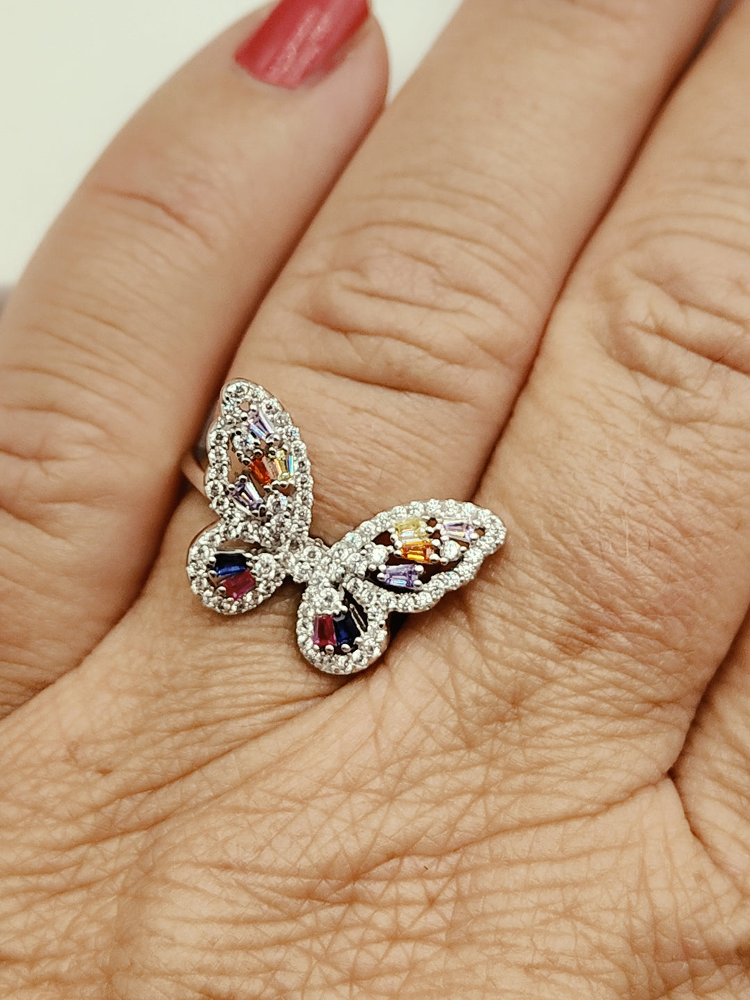 Anello farfalla in zirconi colorati montato su argento