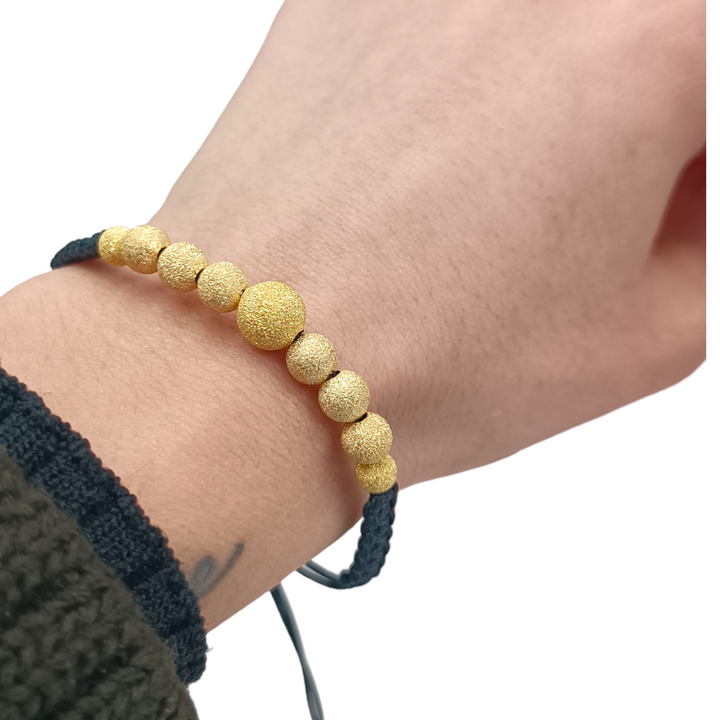 END OF COLLECTION - Bracelet with spheres in gold-plated satin silver mounted on rubber