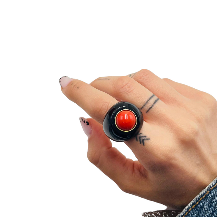 Real red coral ring mounted on black agate 