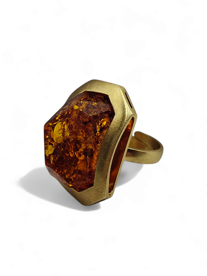 Green and red amber ring mounted on gold plated silver
