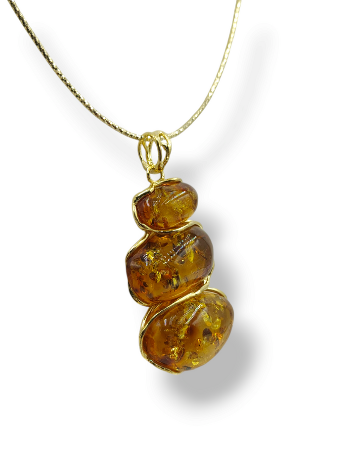 Red amber tris pendant mounted on silver