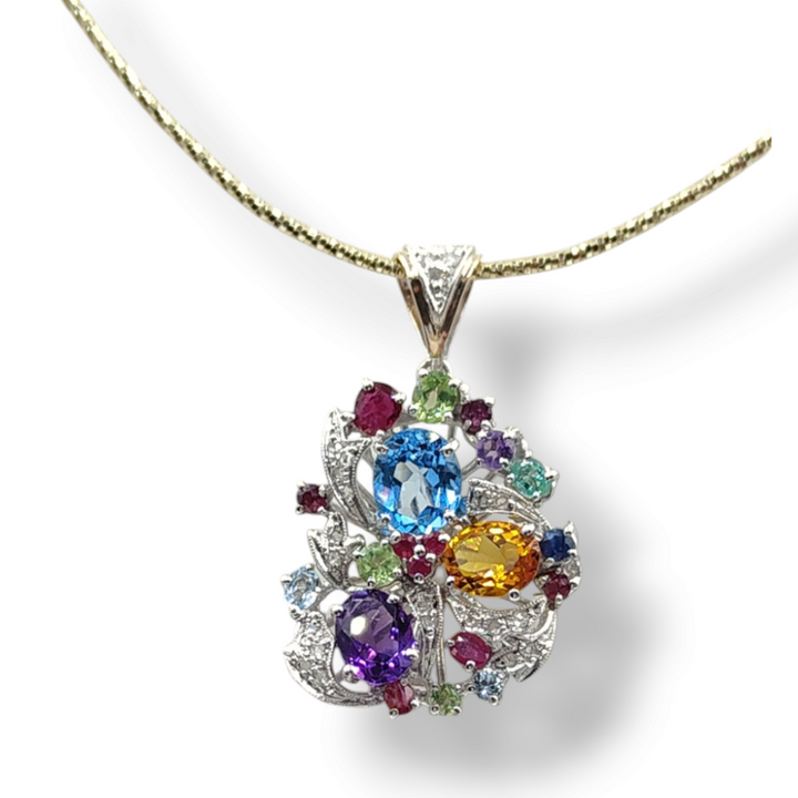 Pendant in diamonds and precious stones mounted on gold