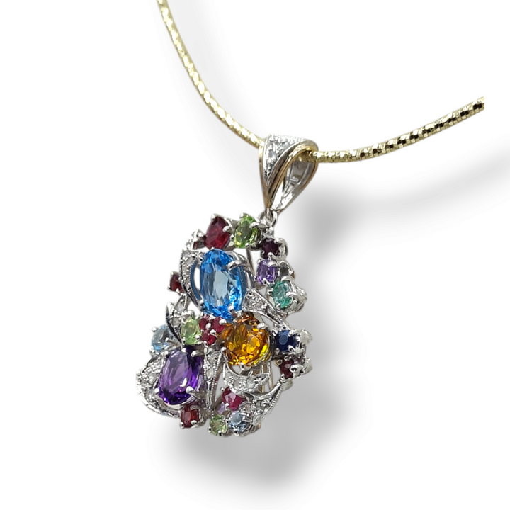 Pendant in diamonds and precious stones mounted on gold