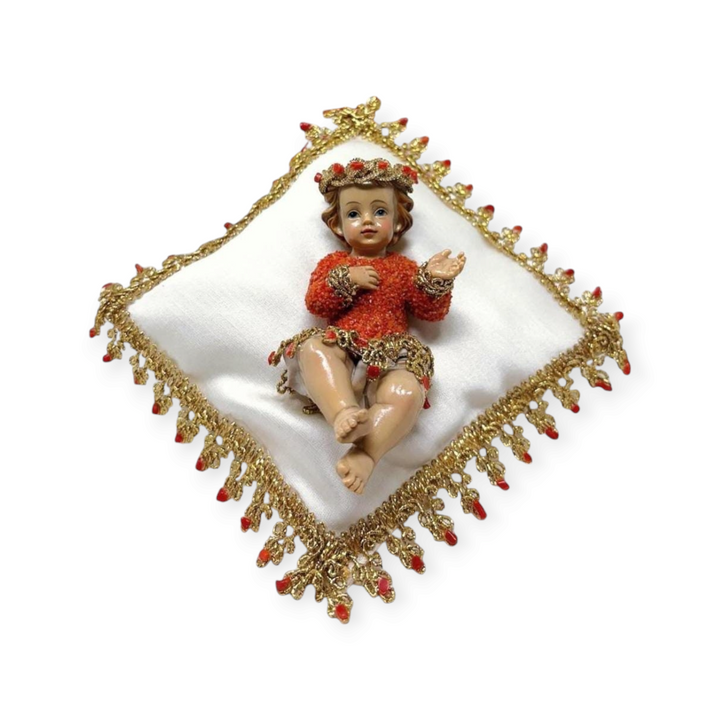 Coral-covered baby boy on pillow