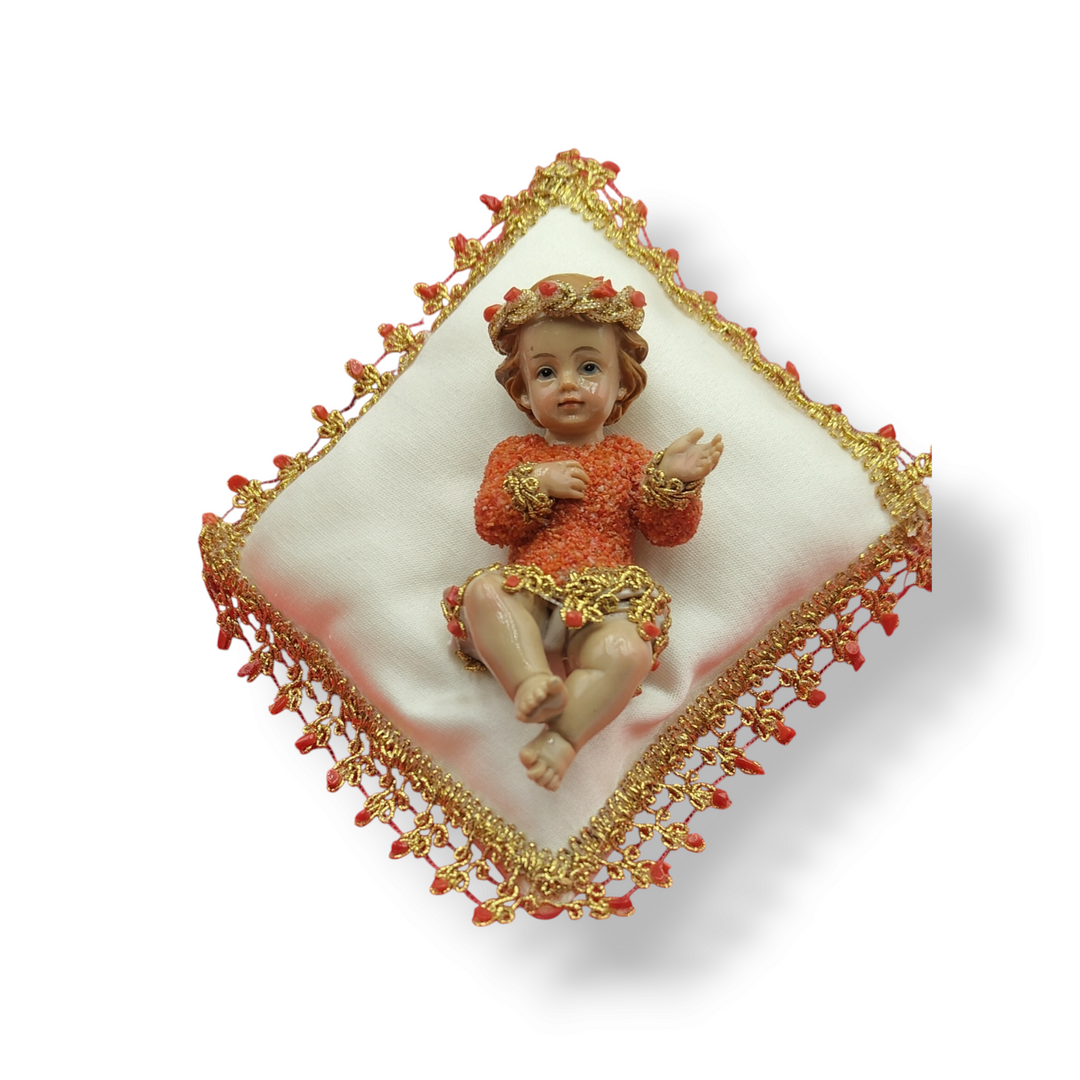 Coral-covered baby boy on pillow