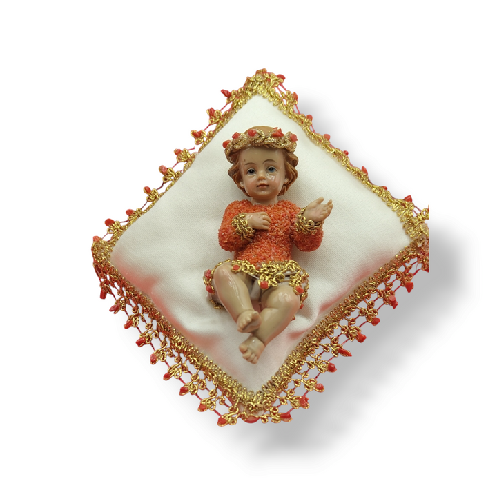 Coral-covered baby boy on pillow